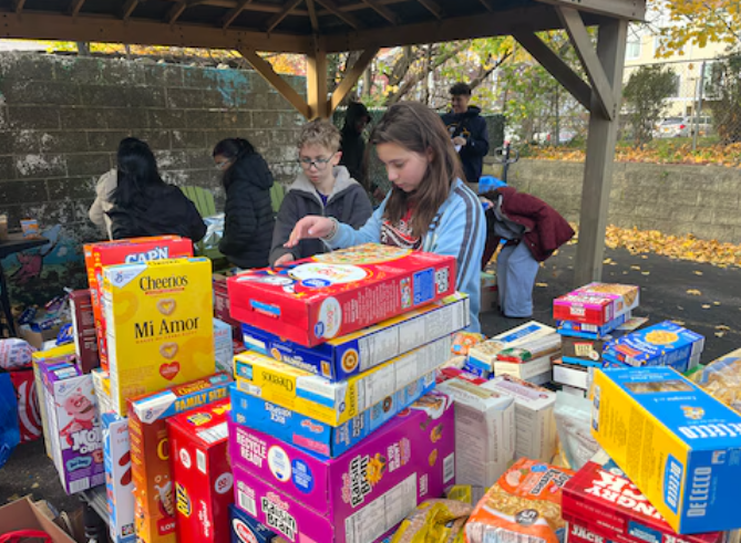 Featured image for “School spirit meets community service as Staten Island students pack meals at food pantry”